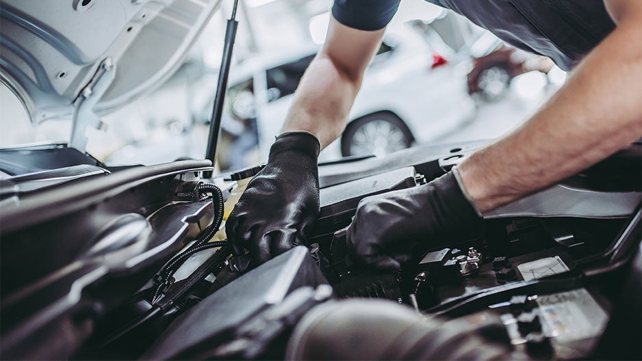 Service technician checking CDJR engine from Bergstrom CDJR Oshkosh