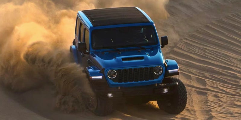2024 Jeep Wrangler driving in sand